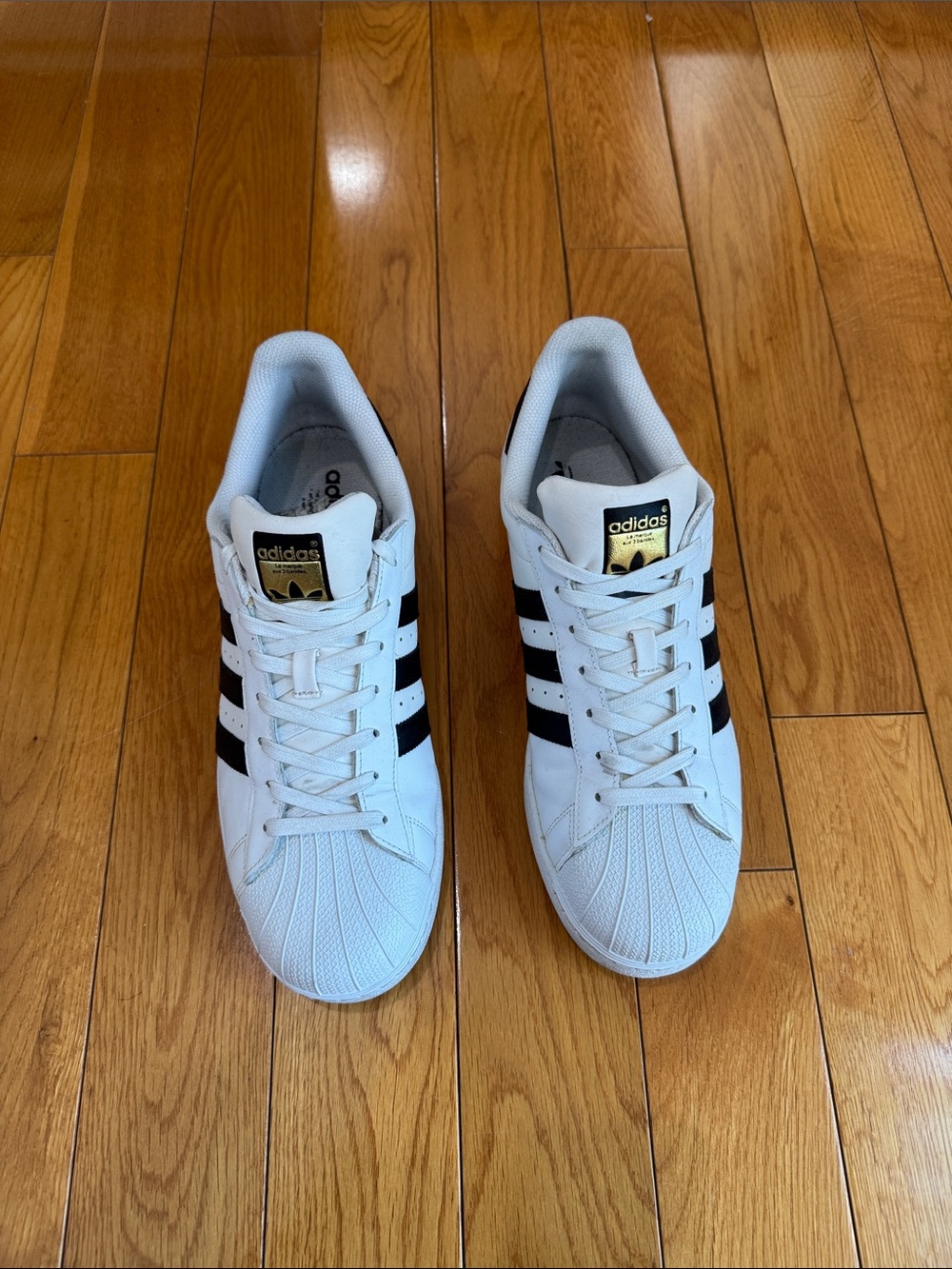 adidas White Sneakers with Black Three-Stripes and Gold Tongue Logo